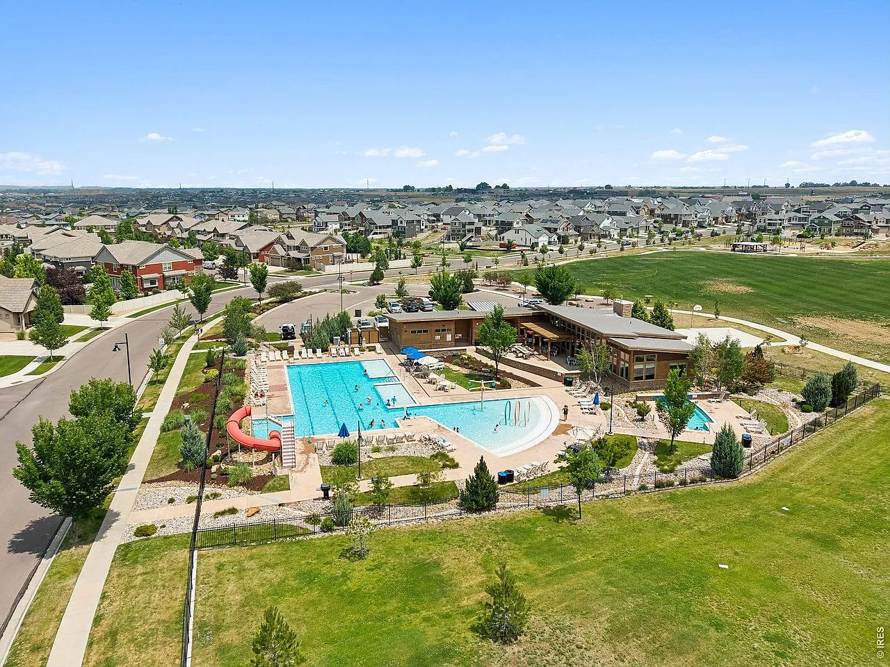 Aerial view of the Erie Highlands community pool, waterslide and clubhouse