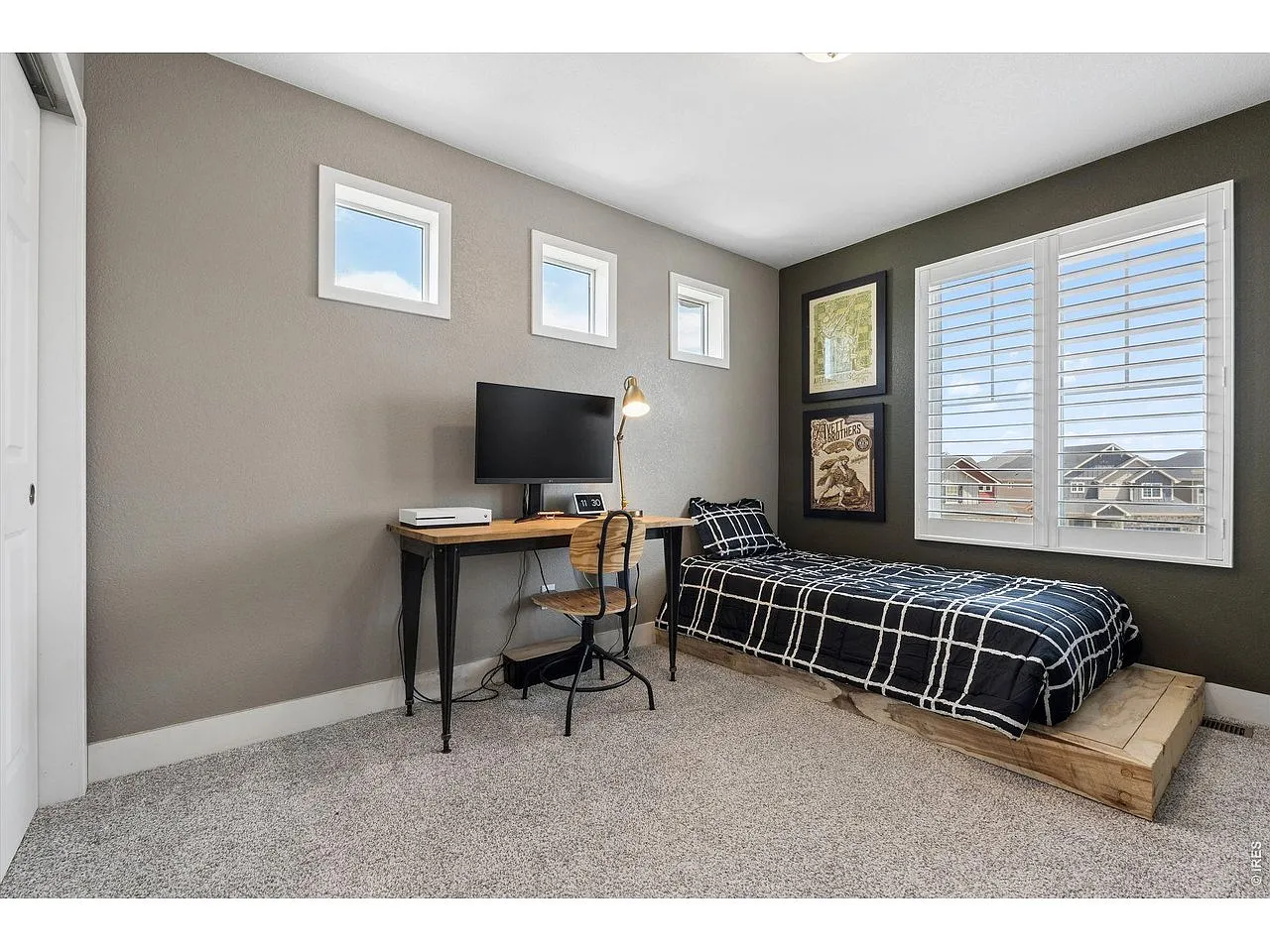 Secondary bedroom with a desk setup and clerestory windows
