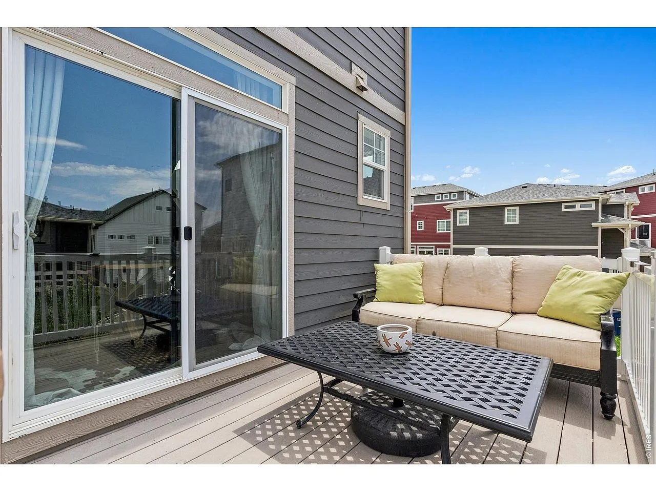 Composite deck off the kitchen with outdoor sofa seating