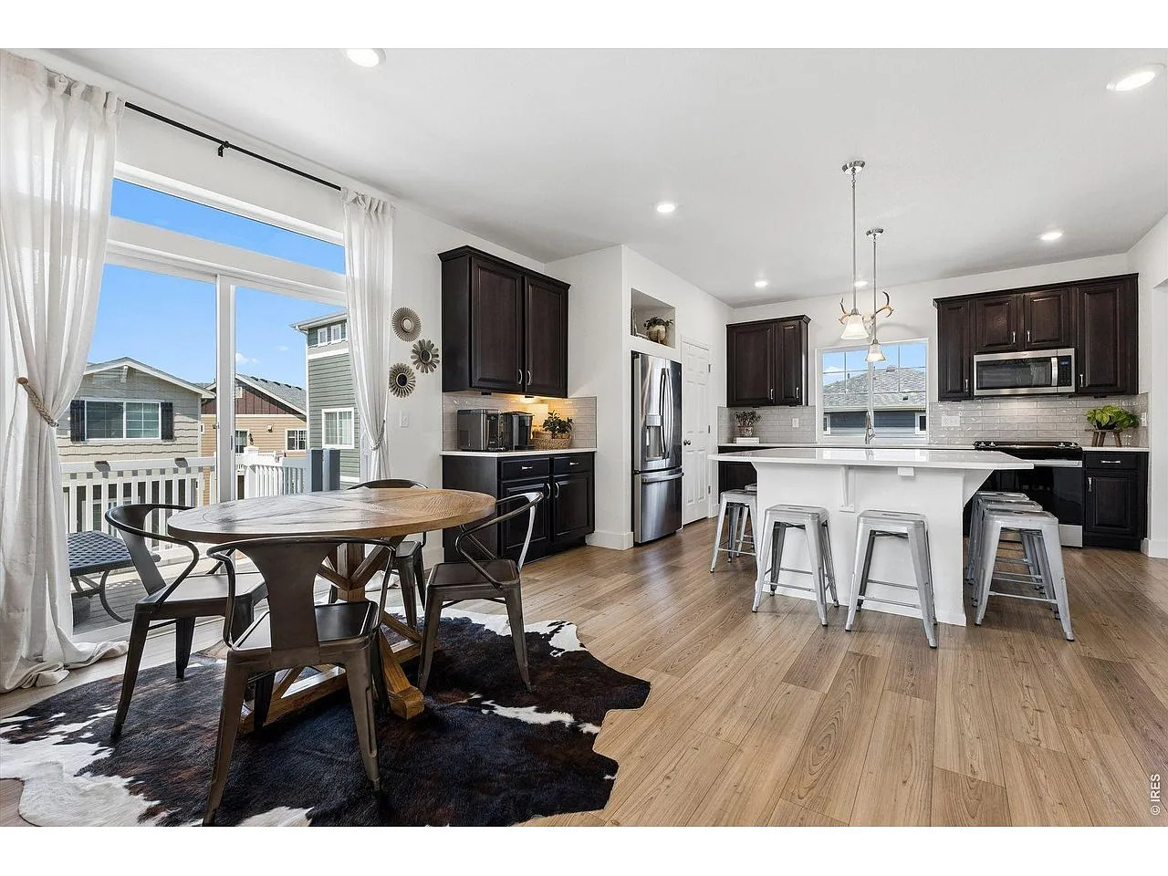 Kitchen and dining nook with sliding door opening to the deck