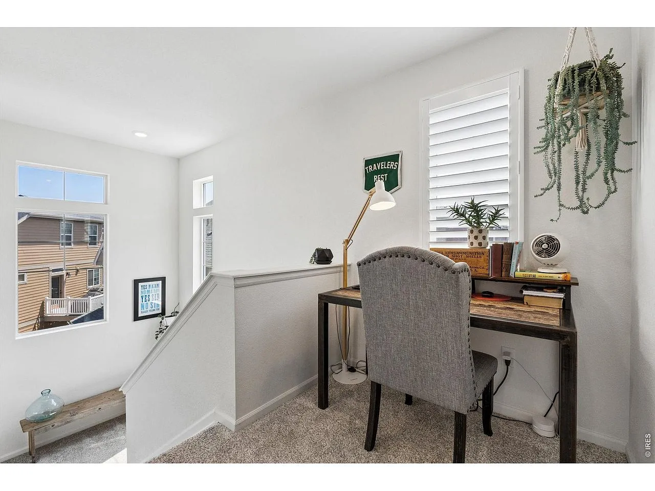 Upstairs landing nook with a built-in desk and window light
