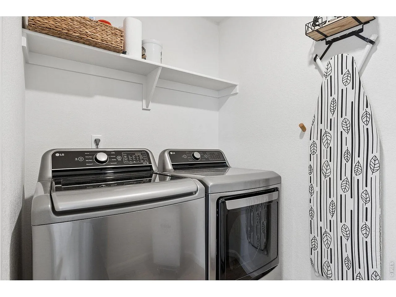 Dedicated laundry room with full-size washer and dryer and open shelving