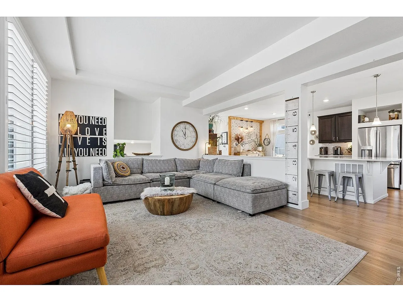 Open-concept living room flowing into the island kitchen