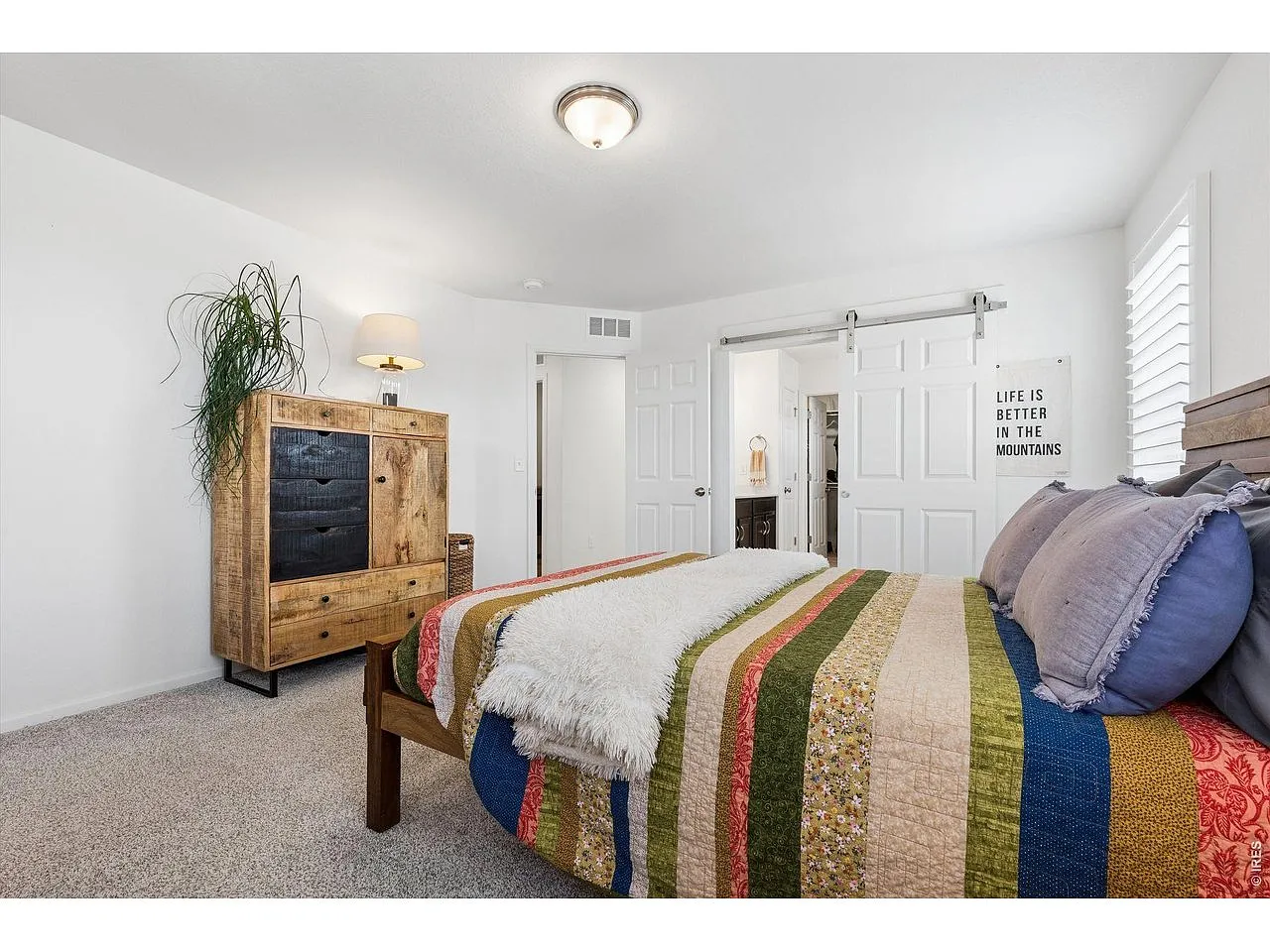 Primary bedroom with sliding barn door to the en-suite bath